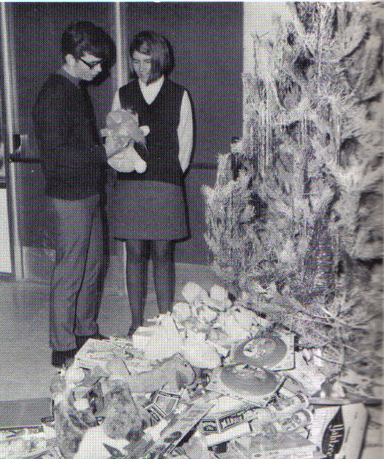 Roy Pea and Jan Hamilton peak at their gifts from Santa