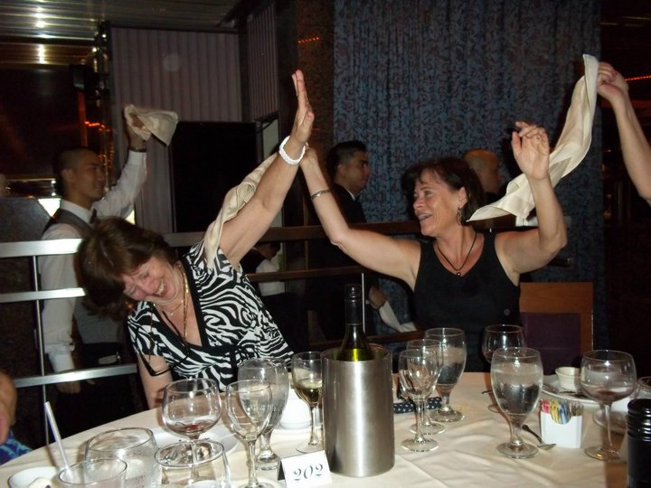 
Sally & Sue whooping it up as wait staff dances for diners